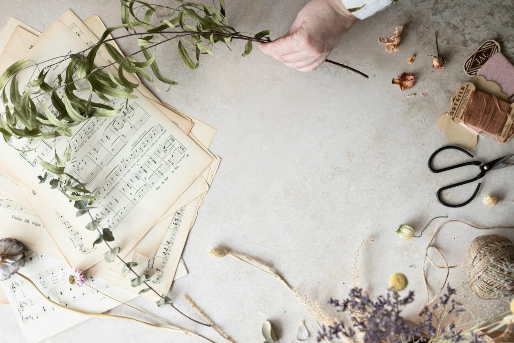 a table topped with lots of papers and flowers