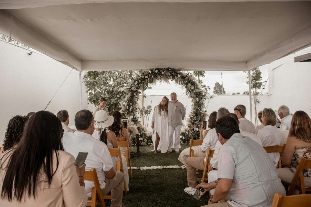 A group of people sitting in chairs under a tent