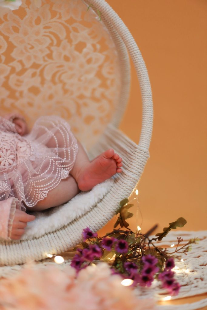 a baby is laying in a white chair